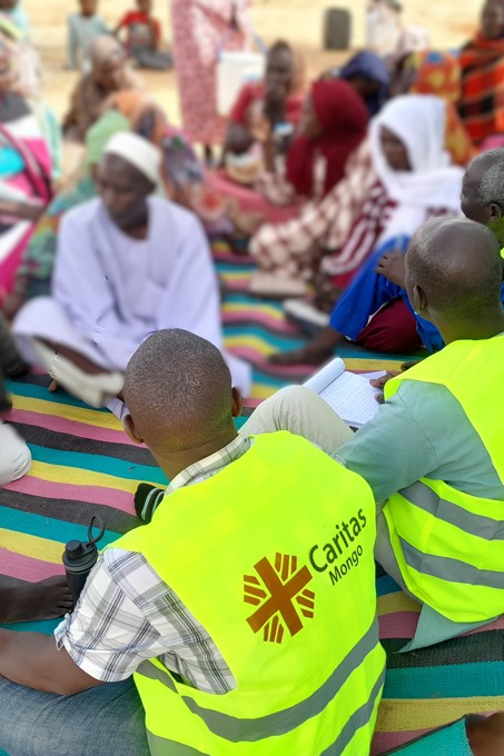 Aid Workers Sit With Sudanese Refugees In Chad Photo Credit Caritas Mongo