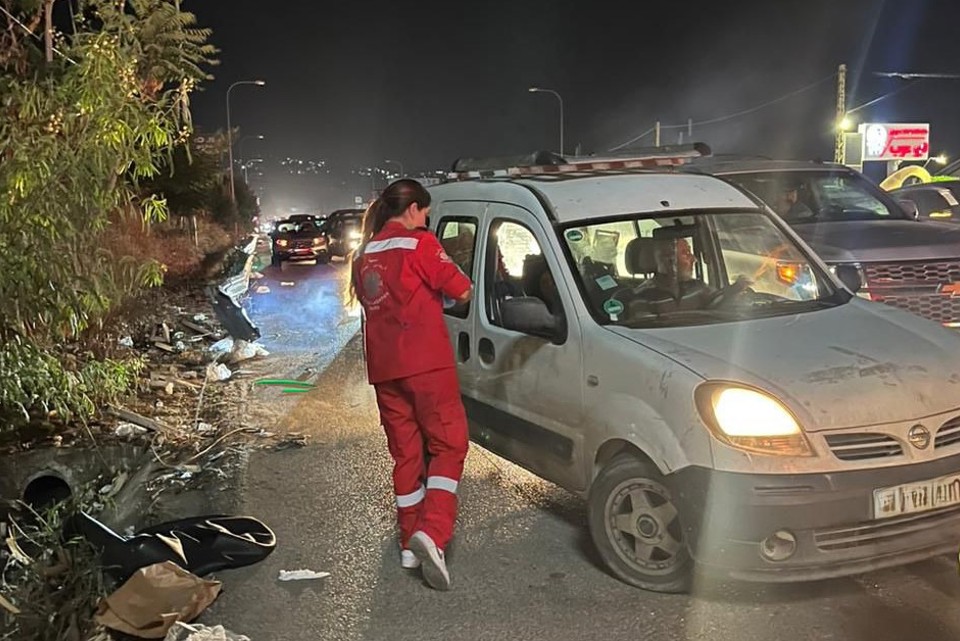 A Caritas Worker Hands Out Water Alongside The Road Photo Credit Caritas Lebanon