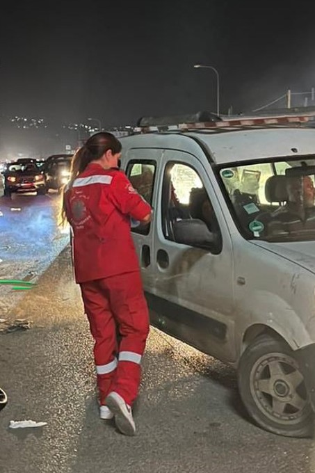 A Caritas Worker Hands Out Water Alongside The Road Photo Credit Caritas Lebanon