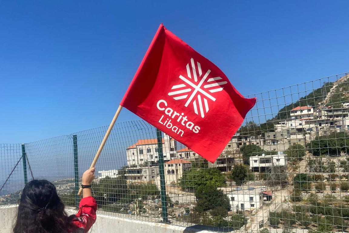 Caritas Lebanon Waving A Flag Photo Credit Caritas Lebanon