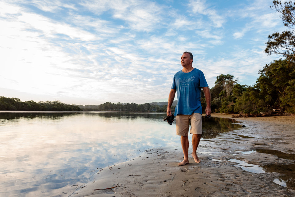 Australian man walking on beach