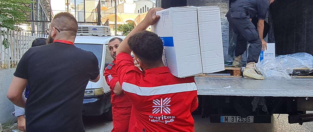 Caritas Lebanon Employees Load Supplies Into A Van Photo Credit Caritas Lebanon