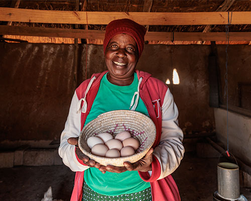 Priscilla Holding Basket Of Eggs