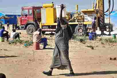 A Pregnant Sudanese Refugee Carrying Water In Neighbouring Chad Photo Credit Caritas Mongo