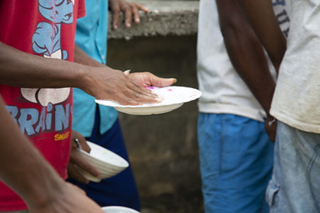 Washing plates by hand in Solomon Islands