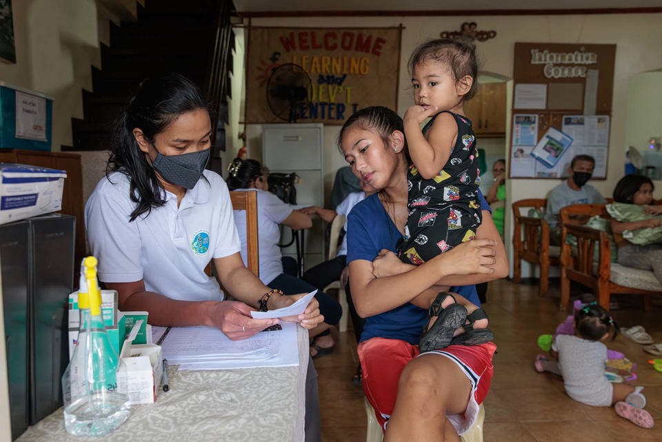 Ronita With Her Children At A Doctors Clinic