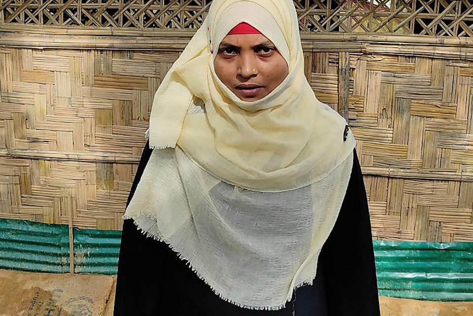 Halima standing outside her home in Cox's Bazar