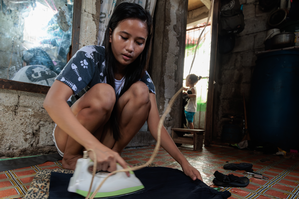 Ronita Ironing Clothing In Her Home (1)