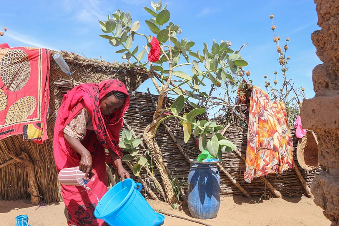 A Woman Uses A Bucket She Received During A Distribution Organized By Caritas Mongo In The Chadian Border Town Of Adre Photo By