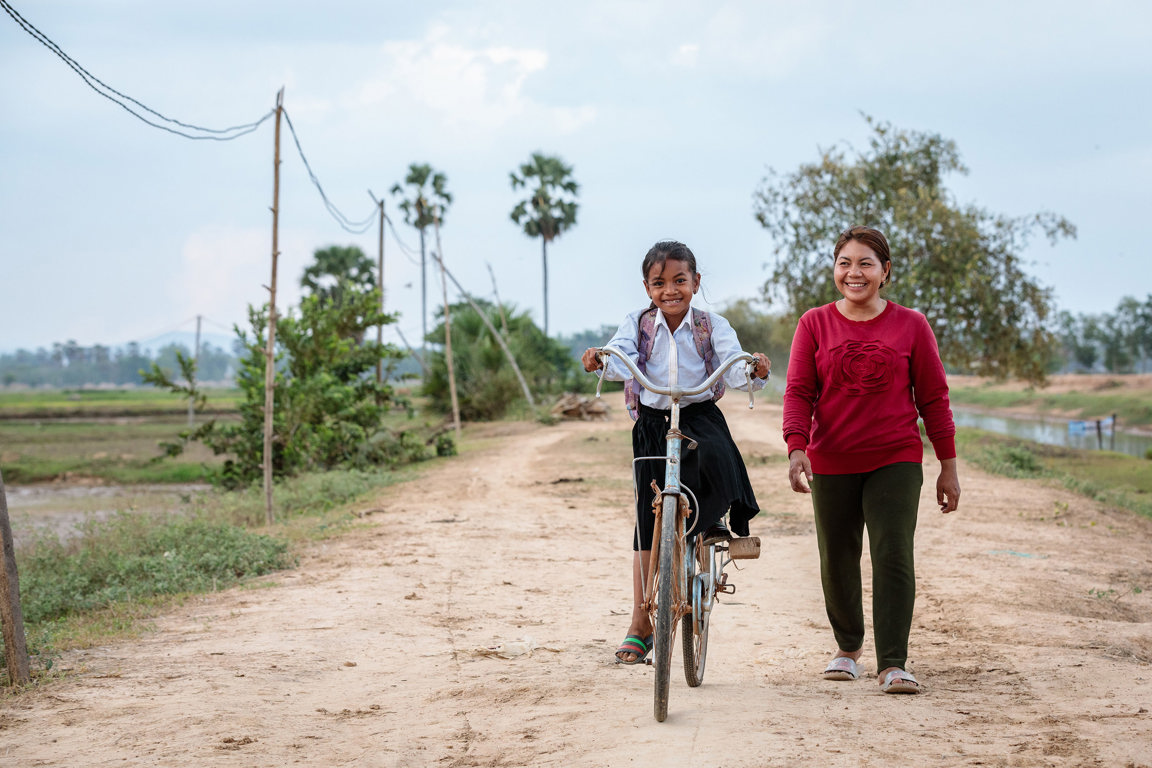 Phany walks with her daughter to school from their home in Western Cambodia (1)