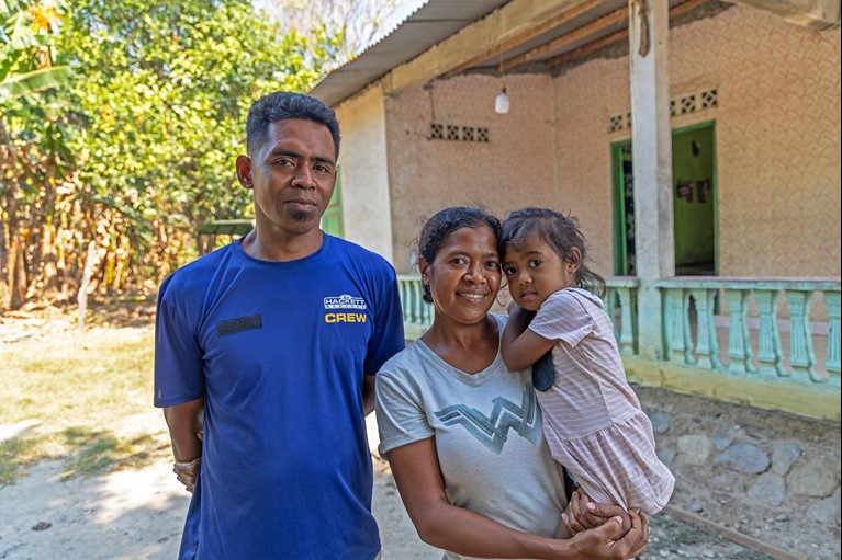 Chiquito with his wife, Maria, and two-year-old daughter, Carabela, outside their home in Timor Leste. Photo: Tim Lam/Caritas Australia