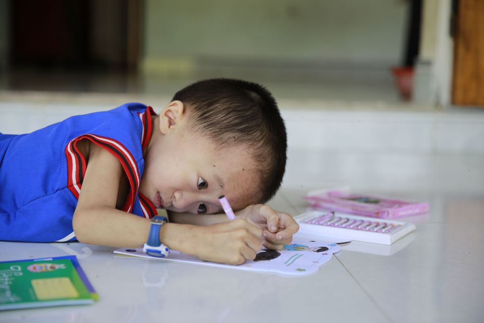 young child from vietnam doing School Work