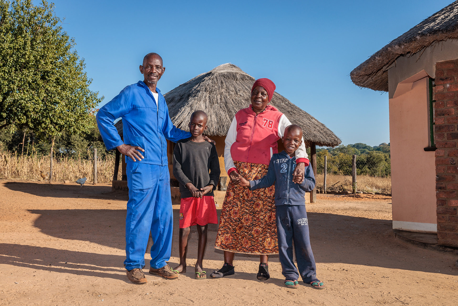 Fighting Food Insecurity In Zimbabwe   Priscilla With Her Family Outside Their Home 