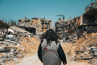 Gaza HET A Caritas Worker Walks Through The Destruction In Gaza Photo Credit Caritas Jerusalem