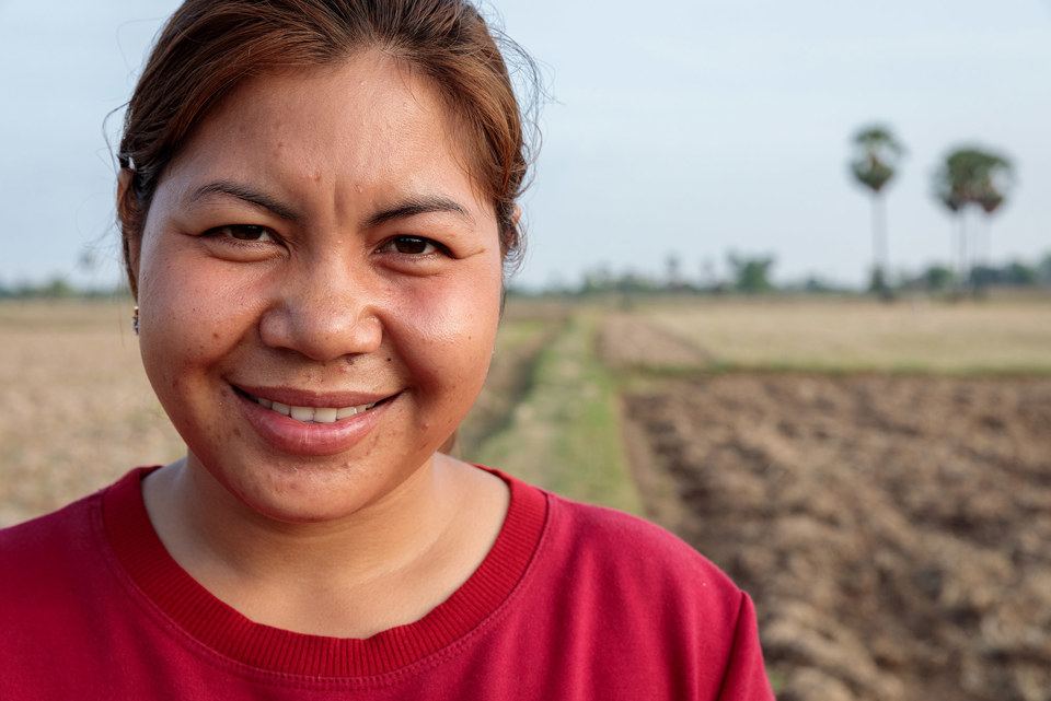 Phany standing in a field in western Cambodia