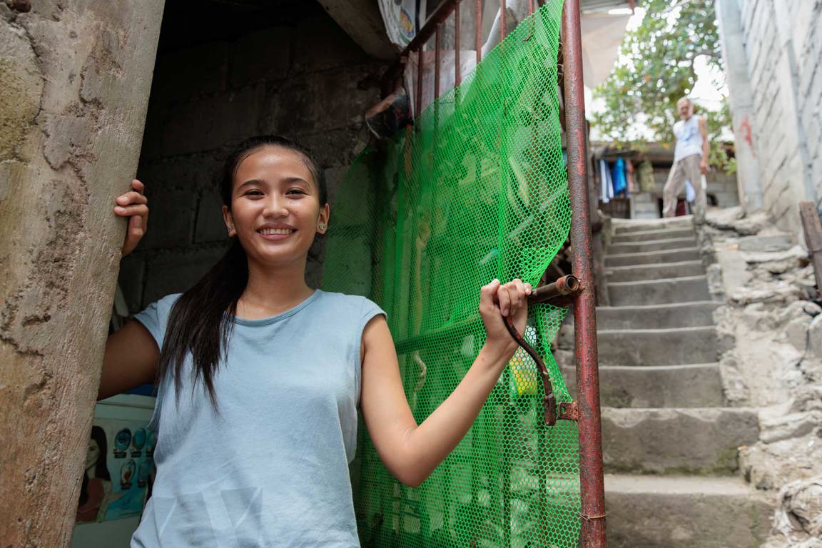 Ronita Smiling Outside Her Home In Philipines