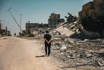 A Man Walks Amid The Razedbuildings In Gaza Photo Credit Caritas Jerusalem