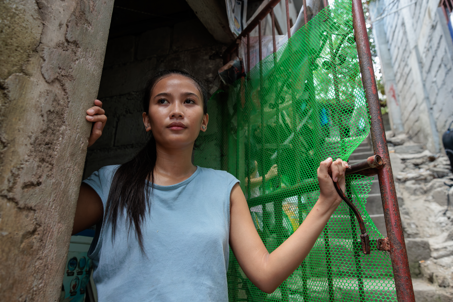 Ronita Looking Outside Of Her Home In The Phillipines