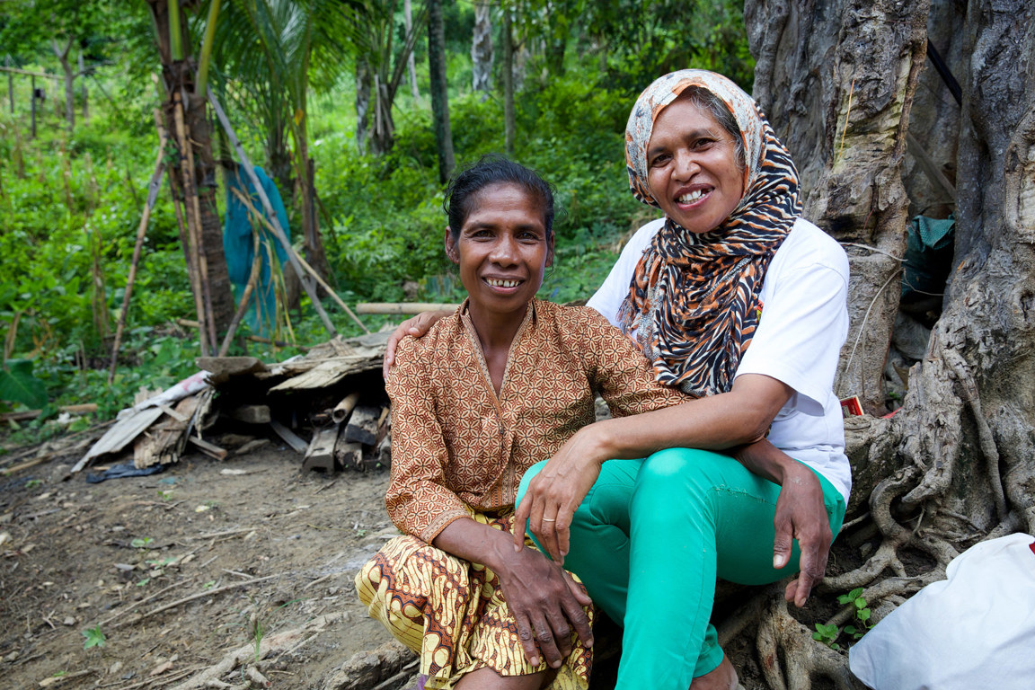 Martina outside her home talking with her councillor from a women's refuge in Timor-Leste