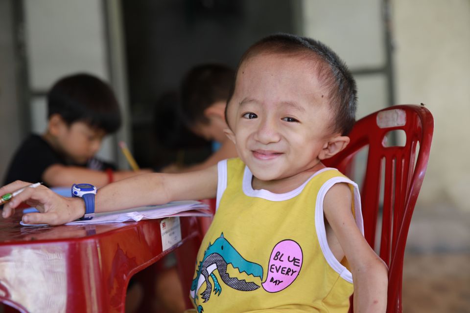 Child sitting at chair in classroom