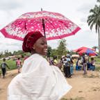 Woman with brightly coloured umbrella in the Democratic Republic of the Congo