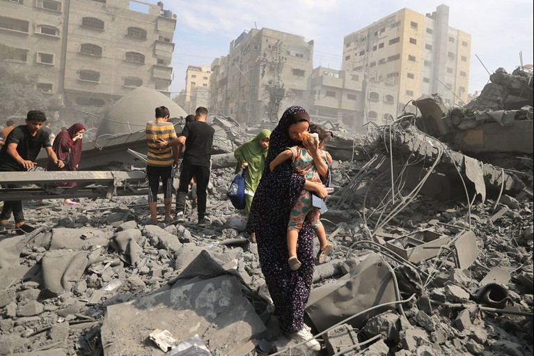 Palestinians evacuate the area following an Israeli airstrike on the Sousi mosque in Gaza City on October 9, 2023. Photo Mahmud Hams Getty Images