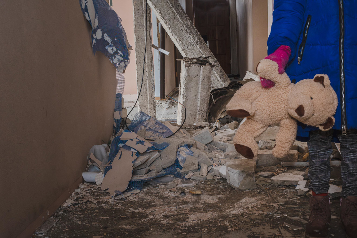 A Child Holds A Teddy Amid The Destruction Photo Credit Elisabeth Sellmeier For Caritas Vienna