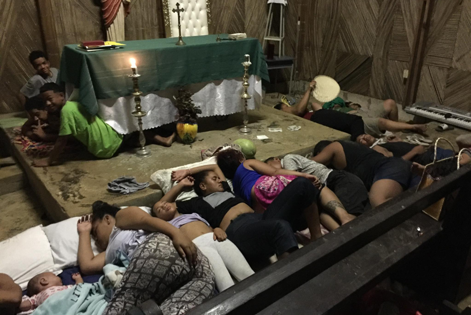 People in Tonga seeking refuge in a Church