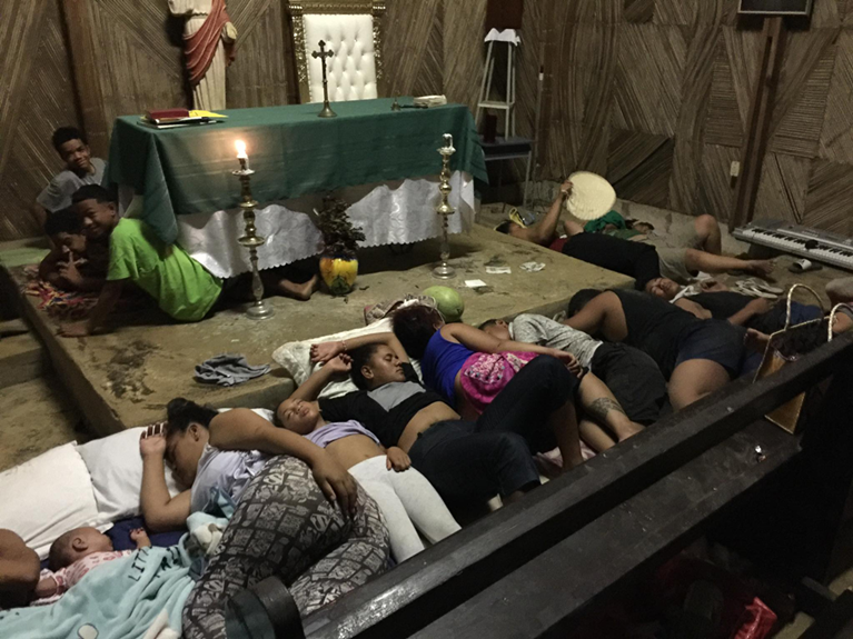 After the volcanic eruption and tsunami in Tonga, any people from the community sought refuge in a chapel on the top of a hill. Everyone slept where they could on the pews of the chapel, some staying at the chapel for up to a week. Credit: Pauline Bourke.

