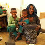 Woman With Her Family In IDP Camp In Northern Ethiopia. Photo Caritas Australia